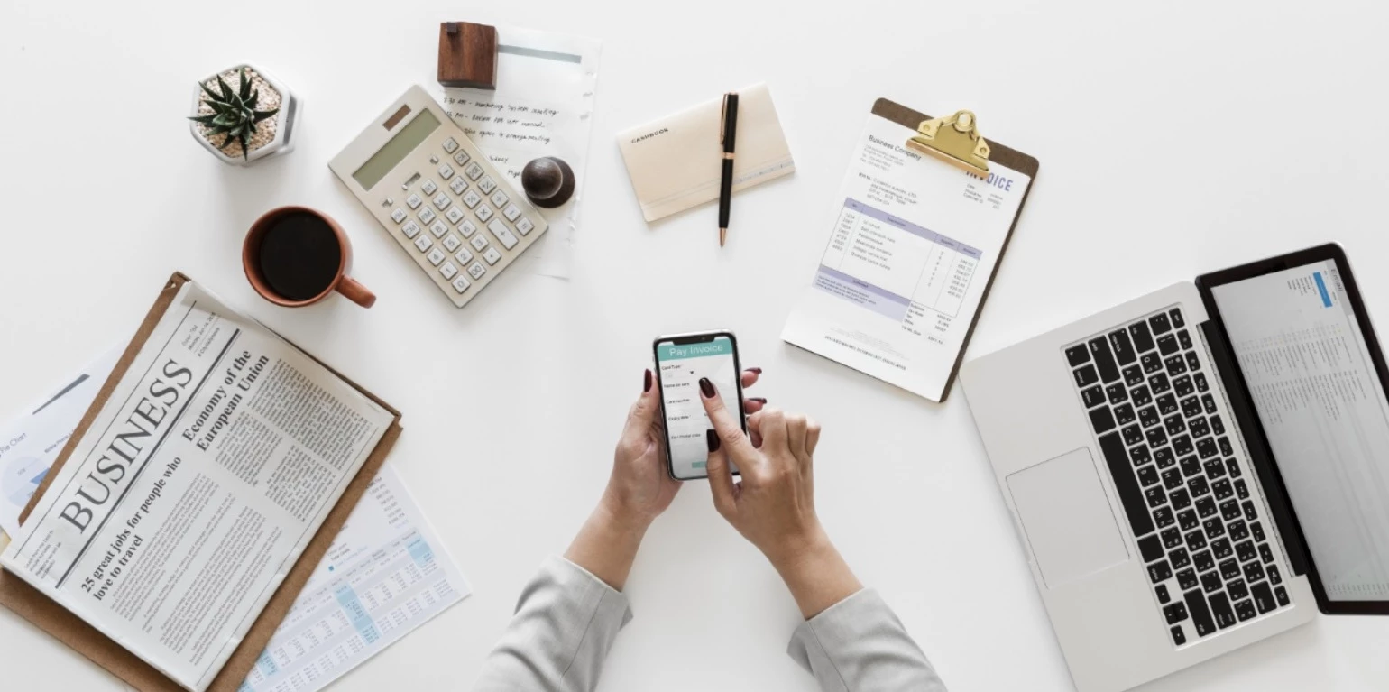 Business desk with resume documents, clipboard and laptop — ATS optimization in a resume