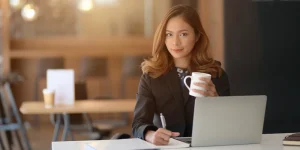 Professional writing a winning resume on laptop — resume writing tips 2023