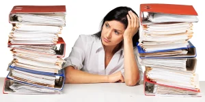 Recruiter sorting through stack of resumes — tips for fast resume screening