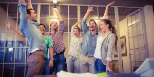 Colleagues shaking hands building workplace trust — tips for trust in the office