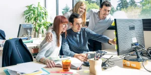 Team celebrating four day work week adoption — considerations for shorter work schedule