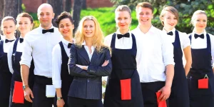 Hospitality professional greeting guests — essential hospitality resume skills for 2023