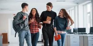 Group of college students walking together on campus - college graduate resume tips to stand out from the crowd