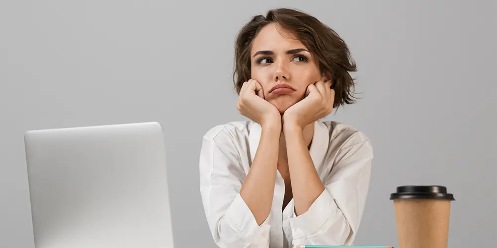 Professional working at a desk revamping their resume — how to fast-track your stalled job search with a resume revamp