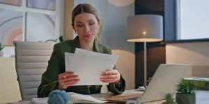 Job seeker carefully proofreading resume document before submitting — review resume before applying