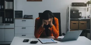 Frustrated job seeker looking at rejected resume application — resume fails no interviews