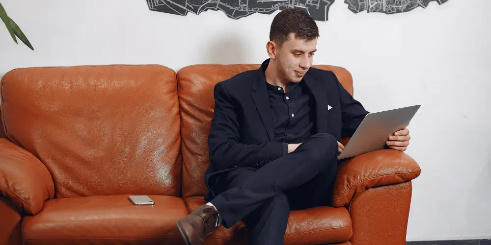 Professional man writing resume on laptop — How to Write a Resume for 2025