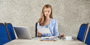 Confident professional holding completed resume — How to Create a Resume That Gets You the Job