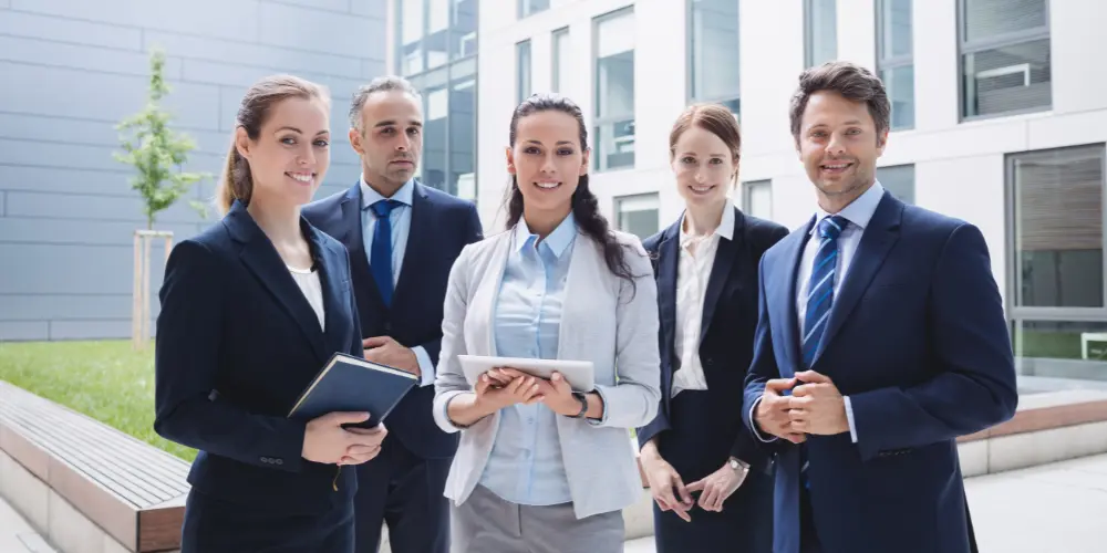 Group of business professionals networking outdoors — how to optimize your LinkedIn profile for a job search