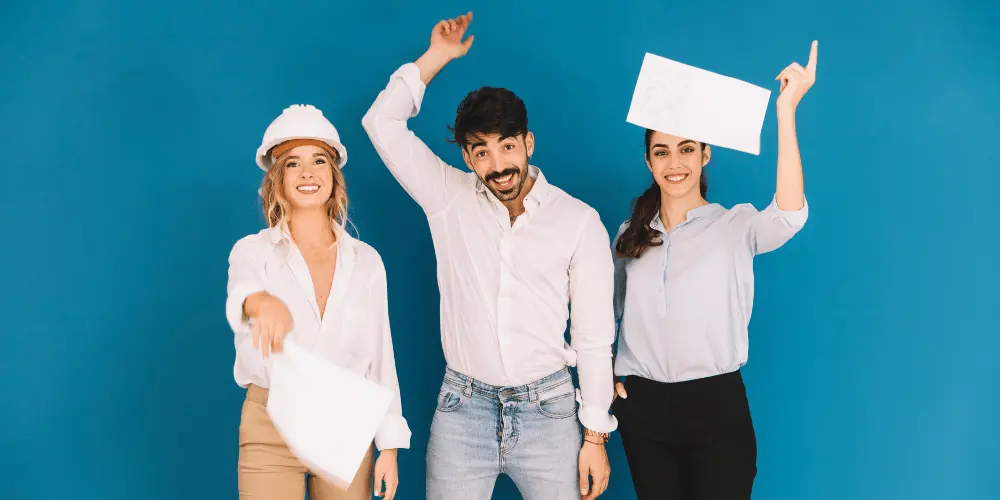 Three cheerful professionals holding blank signs against blue background — customizing your resume is the key to landing interviews