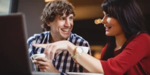 Two professionals networking over coffee and laptops — strategies to tap into the hidden job market