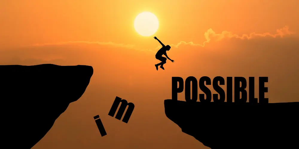 Person leaping between cliffs toward the word Possible at sunset - career feels stuck and how to get it moving again