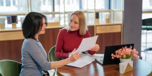 HR professional reviewing a resume with a job candidate - the 3 biggest resume mistakes found after reviewing 1000 resumes