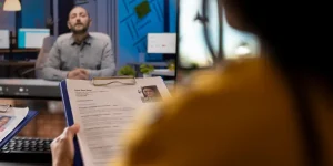 Person reviewing a printed resume during a video call — best resume fonts and layouts for job applications