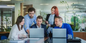 Recruiter and team reviewing resumes together in a modern office, showing what recruiters want beyond experience
